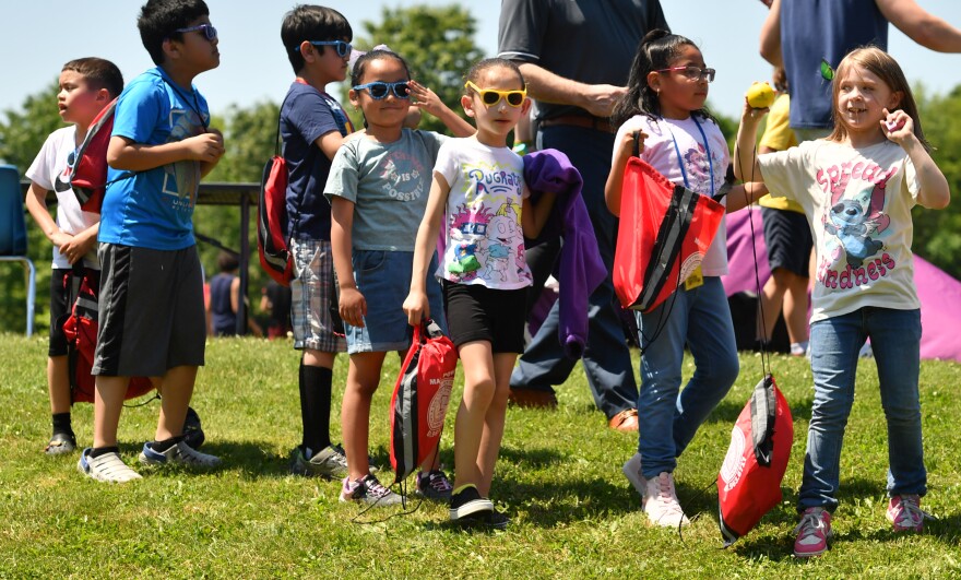 Students line up to visit tables at a mental health fair in Riverside.